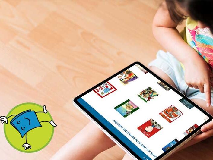 young child looking at book covers on a tablet